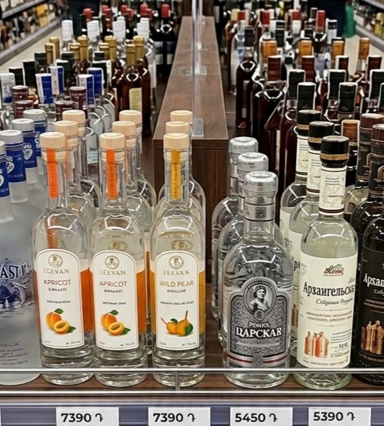 Фруктовые водки на прилавке магазина в Армении